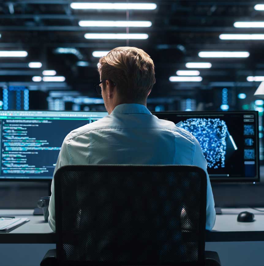 Cybersecurity coder with dual monitors