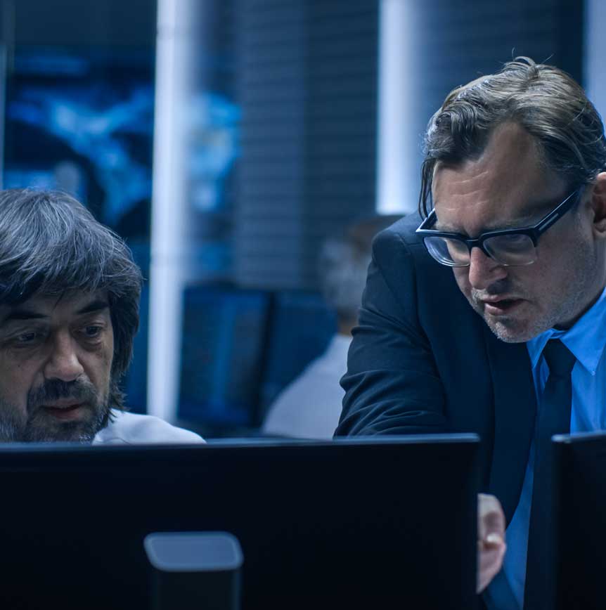 Coworkers collaborating in front of monitors
