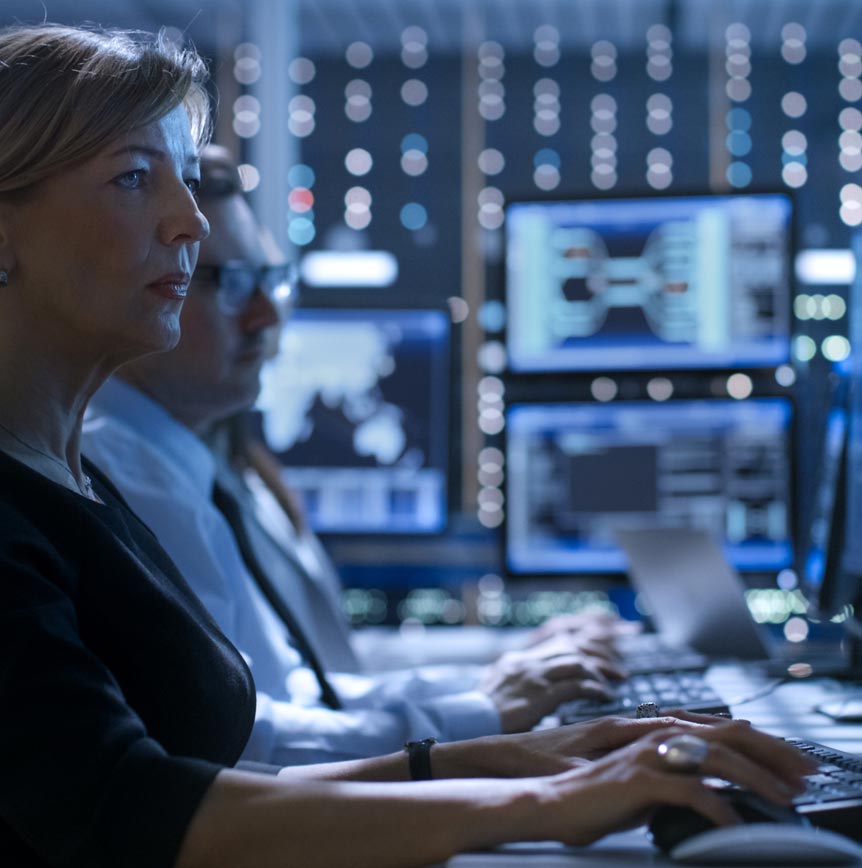 Workers typing at computers in lab