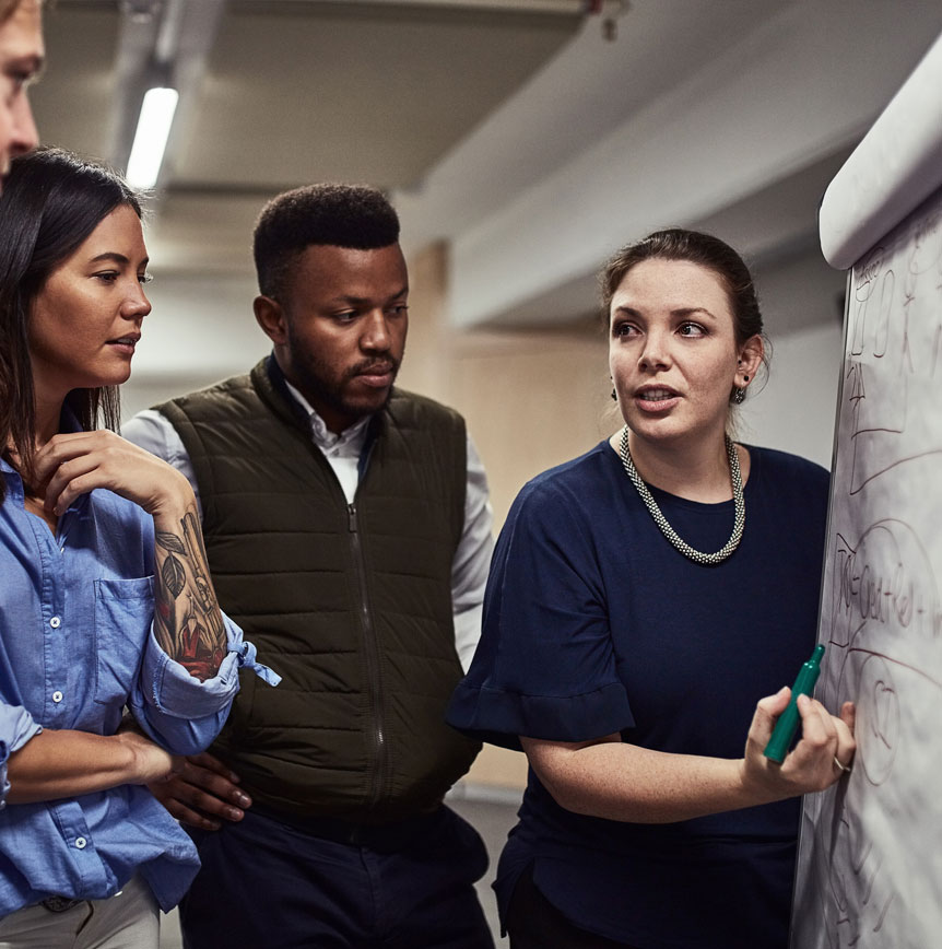 Coworkers at whiteboard project planning