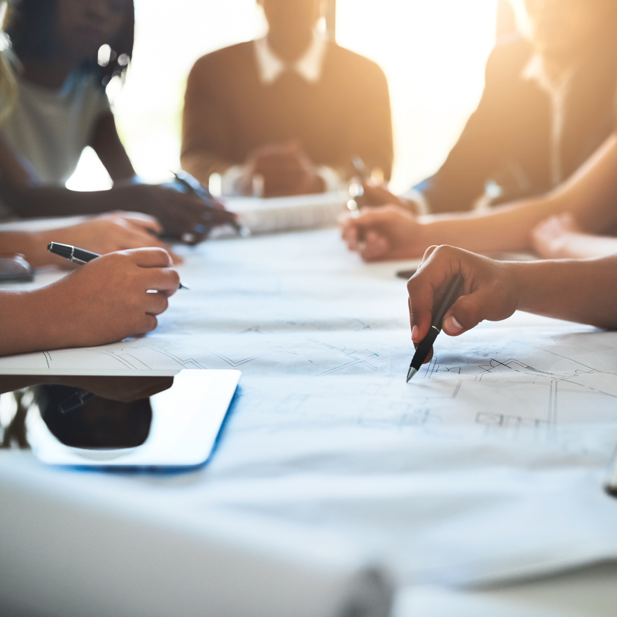 RELI Group employees at table strategizing