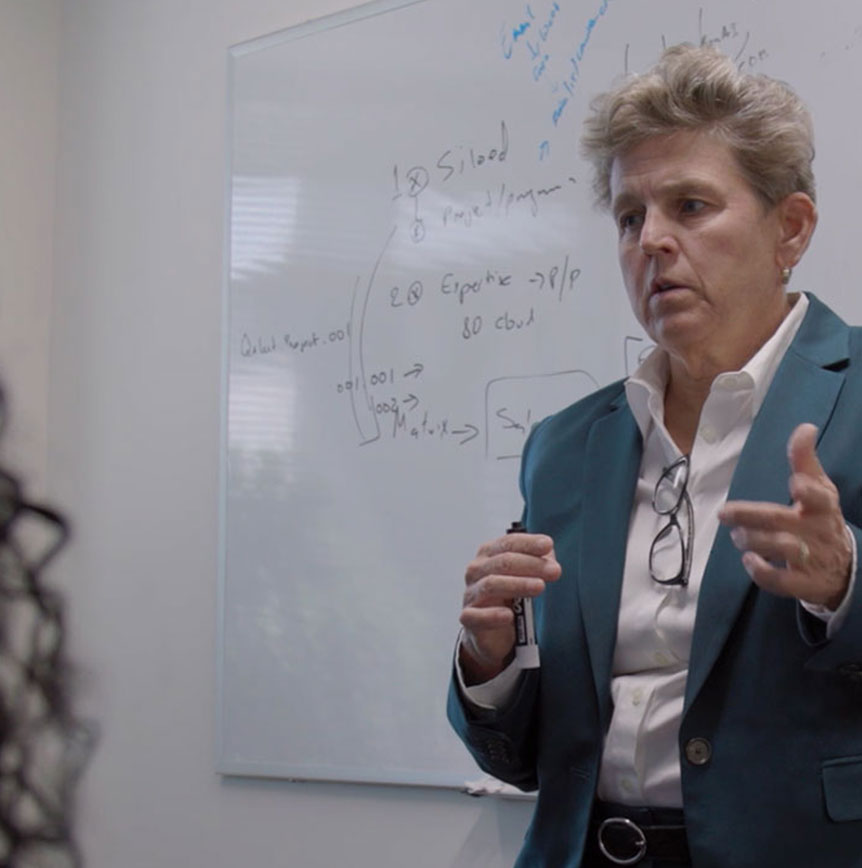 Tish Mossman speaking in front of whiteboard - Featured