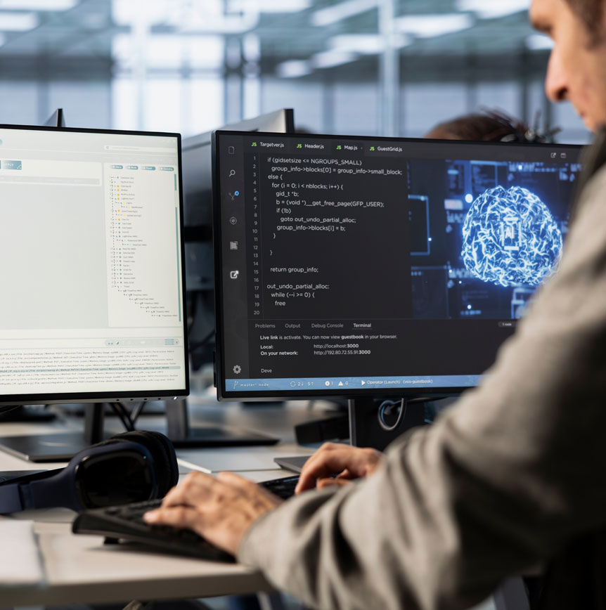 Developer working at a computer workstation with code displayed across multiple monitors and an AI brain visualization, representing software modernization and AI-enabled development.
