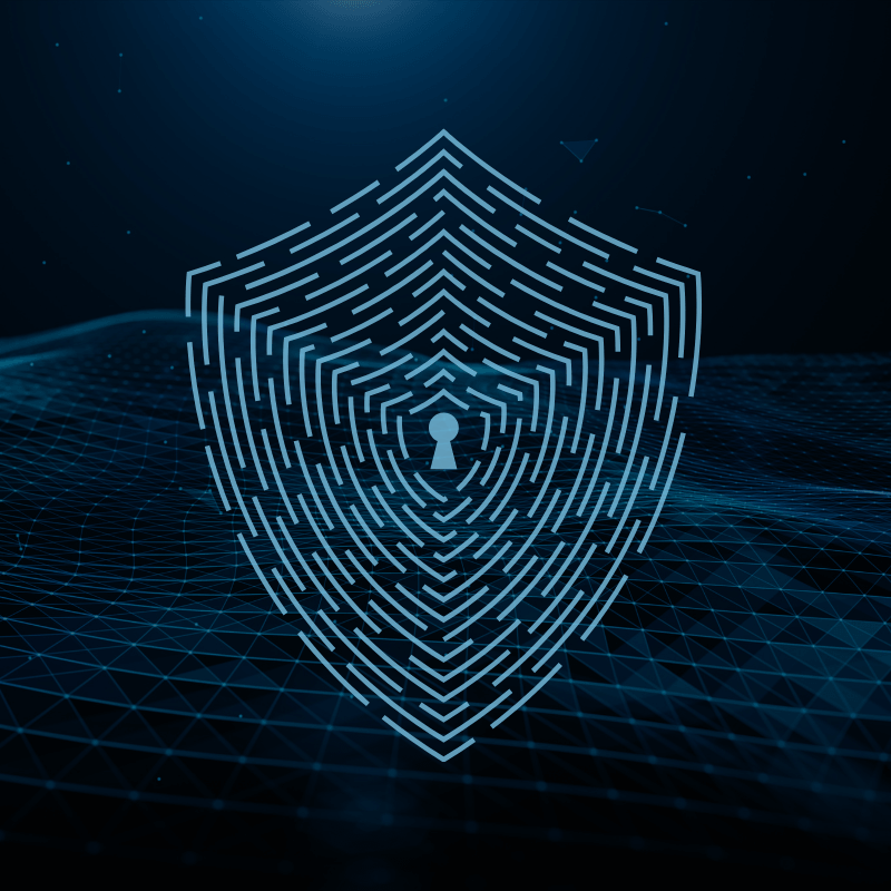 Digital shield with a keyhole over a blue network grid, representing cybersecurity risk management and cloud protection.
