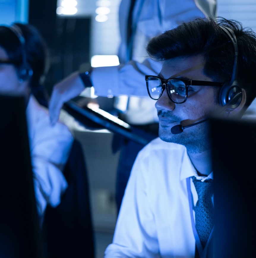 IT support specialist using a headset in a technology operations environment